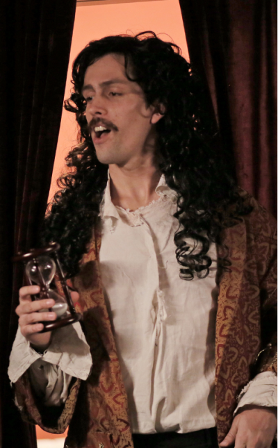 And actor in period costume performing with an hour glass